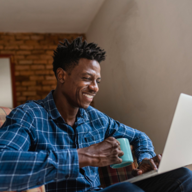 Man smiling at computer reading status of You're on track -  my retirement. Shows progress bar one third of the way there.
