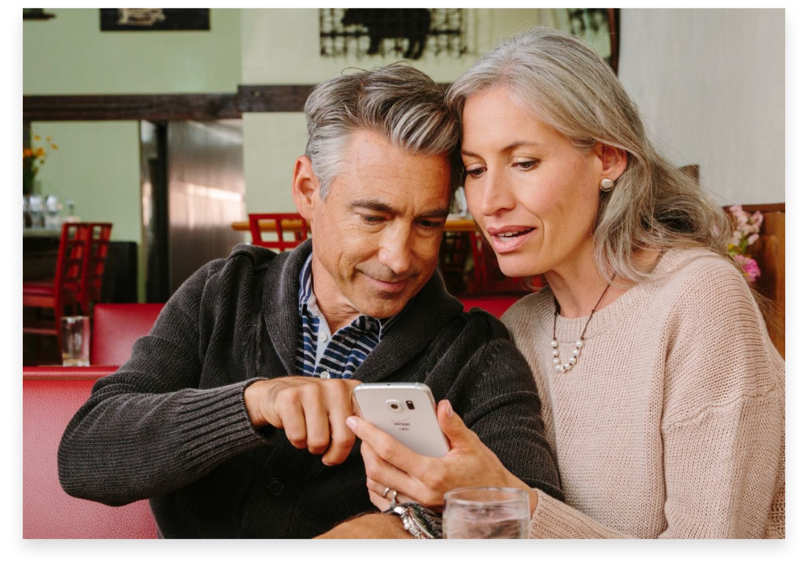 Woman and man reading information on a cell phone
