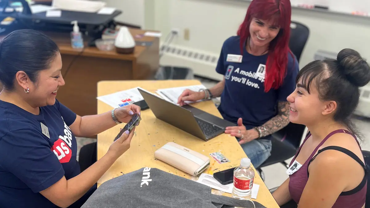Three women in classroom setting.