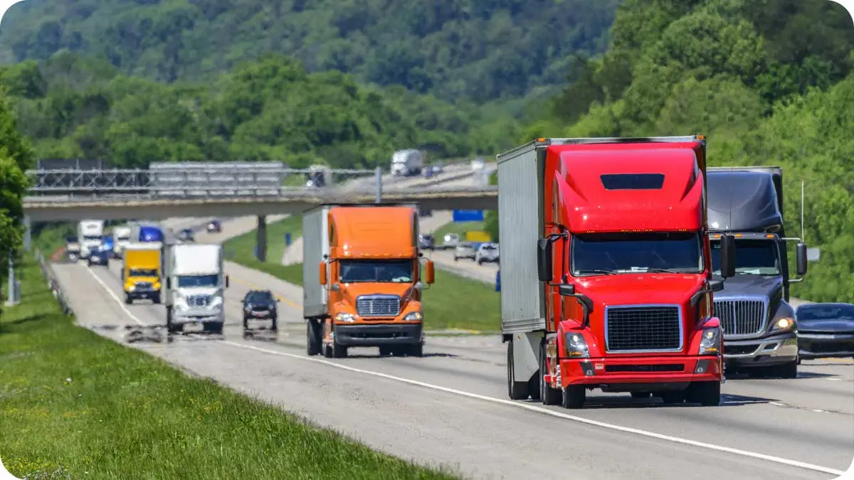 Several semi trailer trucks on a highway