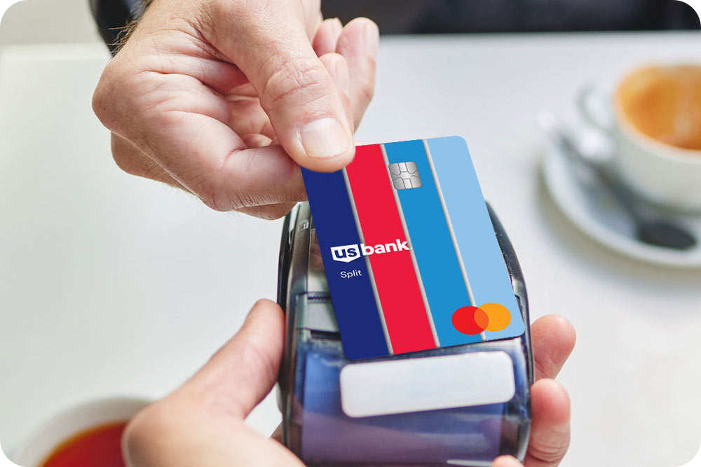 Photo of a person paying with the Split credit card on a tap to pay device