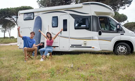 Couple sitting outside RV camping