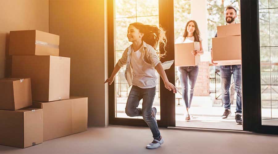 A family unpacking in their new home, making the journey of homeownership a financial reality