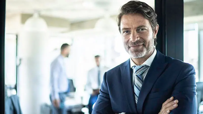 Headshot of a man with arms folded, wearing a suit, getting ready to discuss ETF innovation