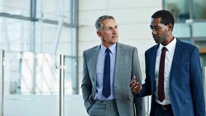 Two men in office discussing depositary banks and collateral agent partners
