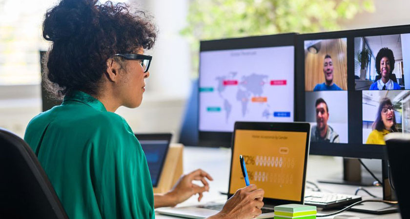 Woman in office on zoom meeting, discussing ways to improve international transactions for their business.