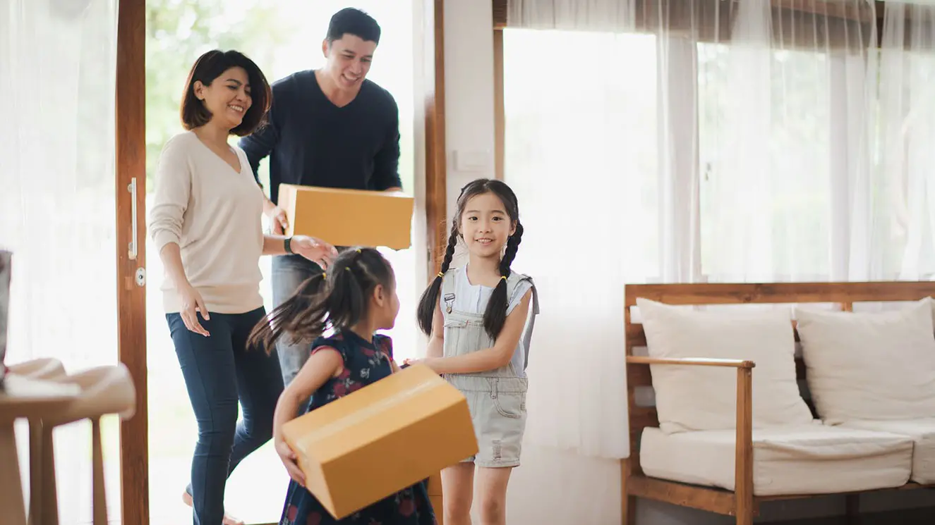A family unloading boxes at their new house.