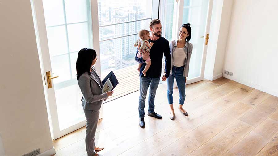 A couple in an empty room preparing for the journey of homeownership