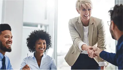 Four colleagues shaking hands in a board room after discussing custody issues