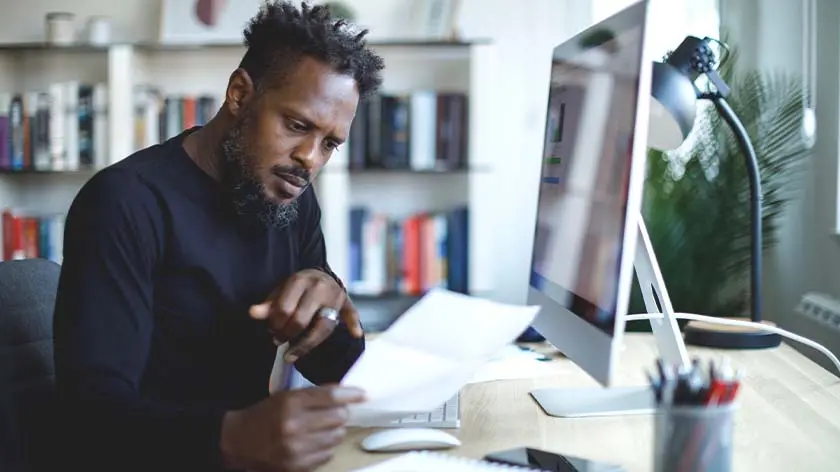 Man working at desk going over finances