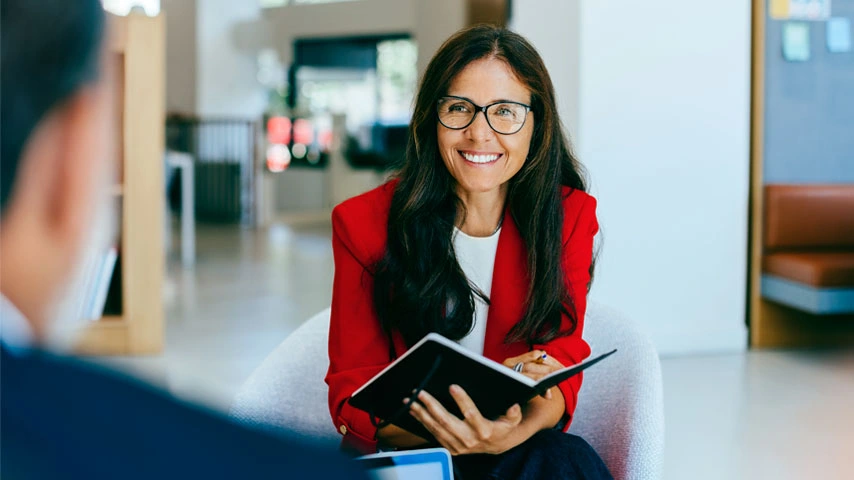 Couple discussing wealth with an advisor at an office