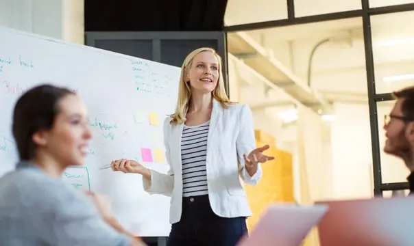 Woman giving whiteboard presentation