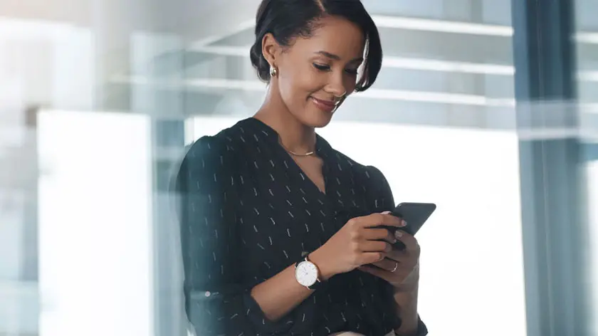 Woman using phone in modern office