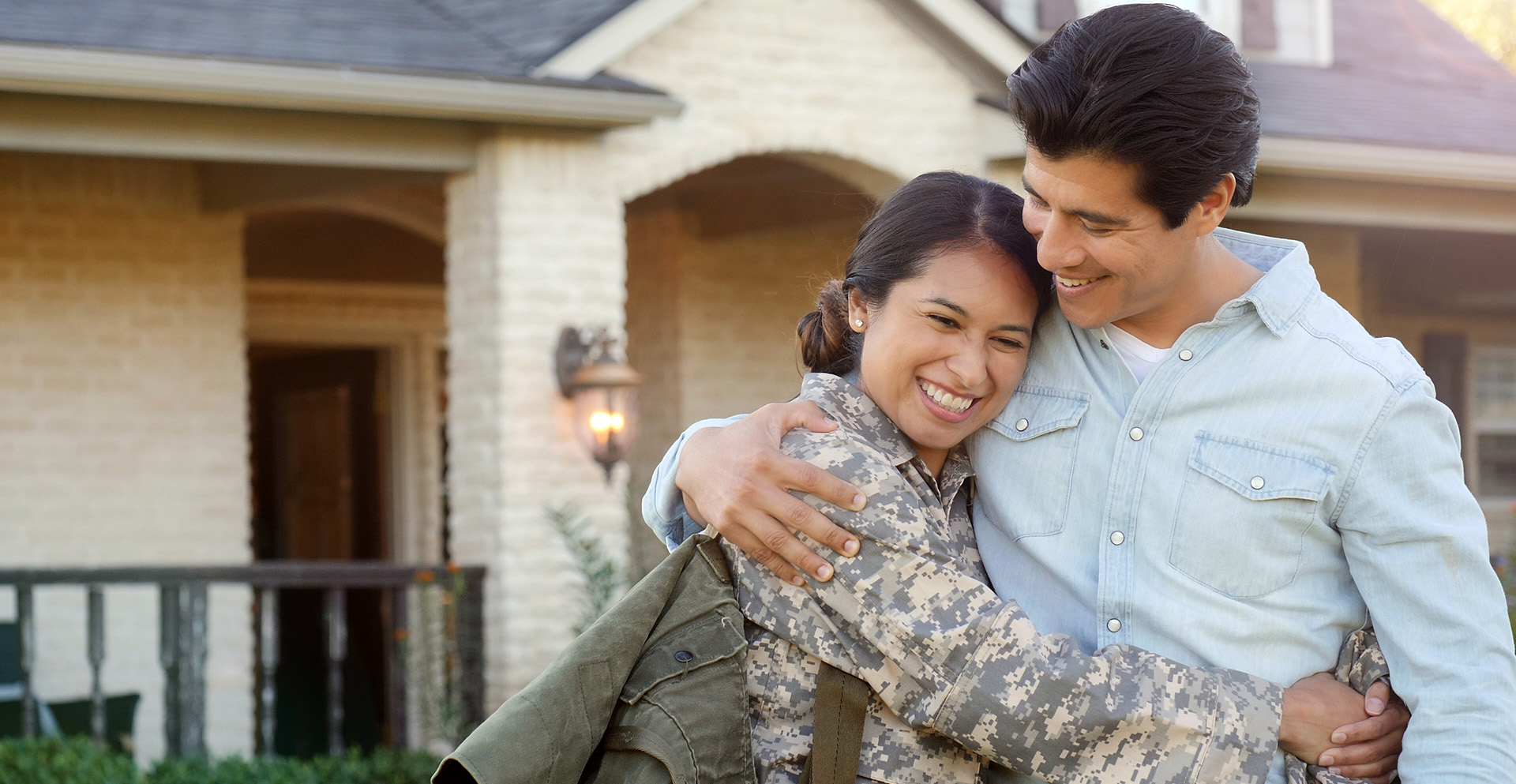 military member hugging her husband