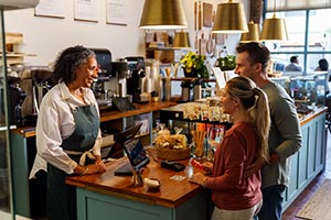 couple ordering at the counter of a coffee shop