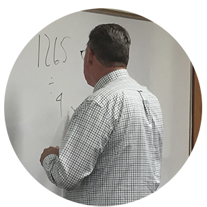 Rick Gaumer at teaching in front of a whiteboard