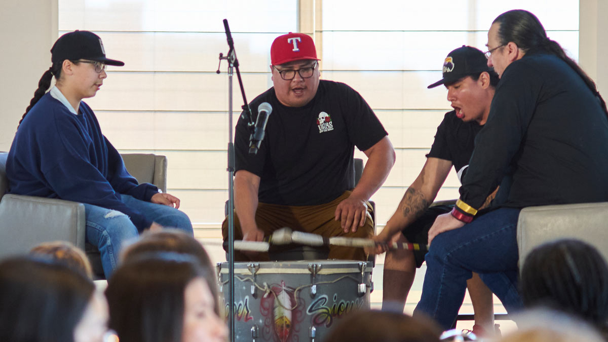 Photo of a group drumming together