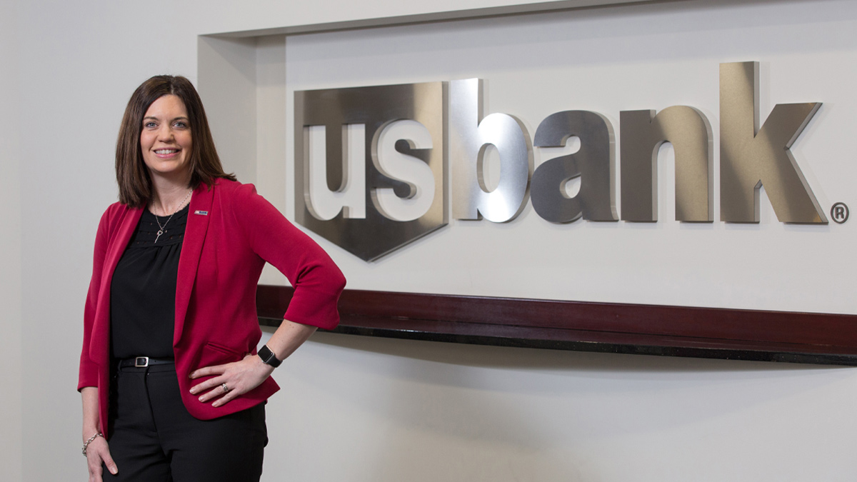 Anita Colvin standing in front of a wall with a U.S. Bank sign