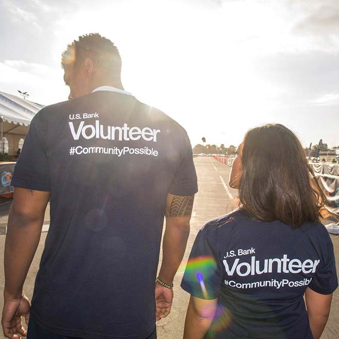 Two U.S. Bank employees in volunteer shirts