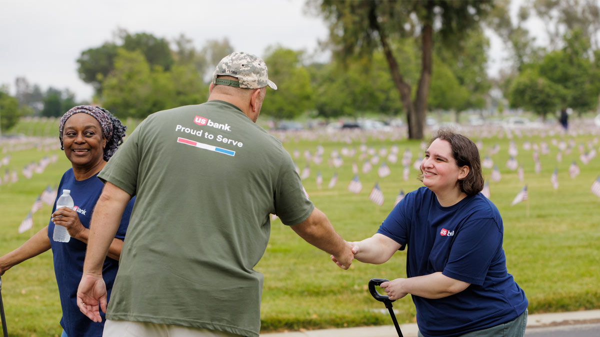 People placing flags at a Veterans cemetary