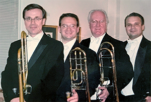 old photo of four trombone players