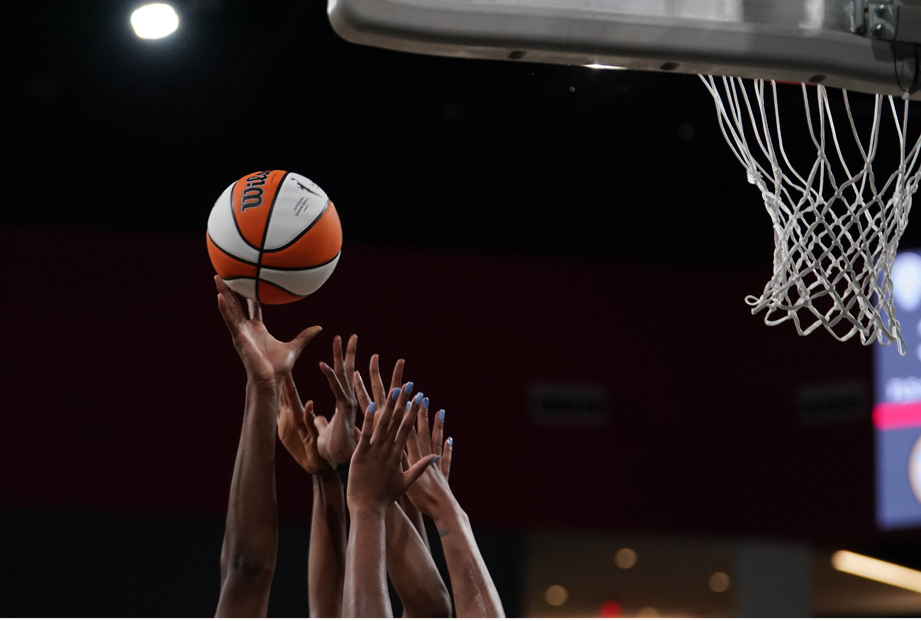 Women's hands striving to grab a rebound basket