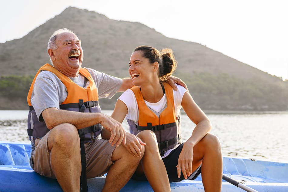 Man and woman smiling on a boat