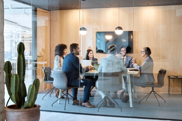 A group of people sitting at a conference table in a conference room
