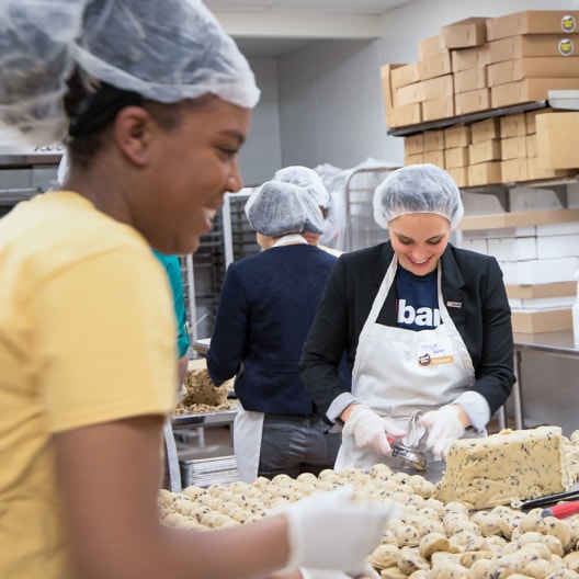 U.S. Bank volunteers work together in a community kitchen