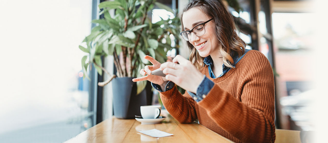 Woman smiling after making a mobile check deposit