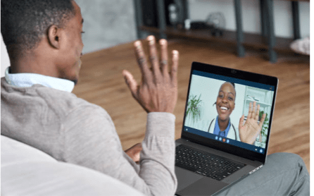 Two people waving to each other on a video call.